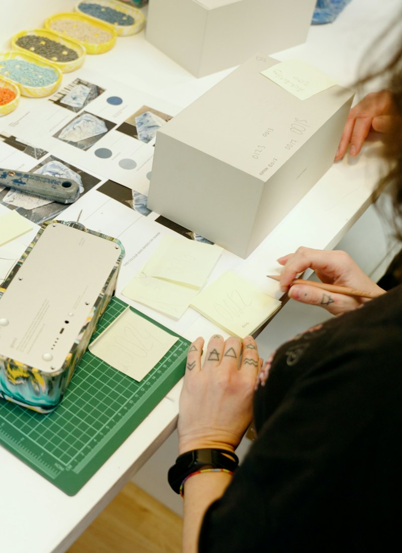 A designer working over printed material