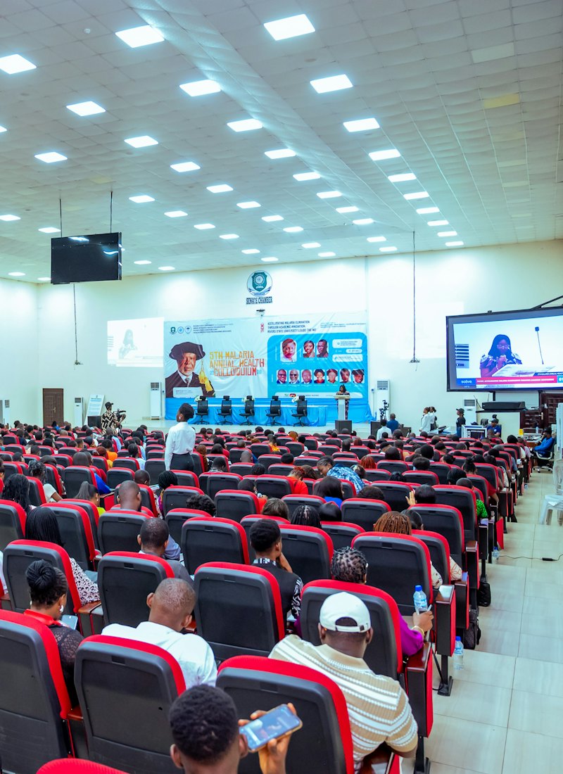 An audience seated in a large conference hall
