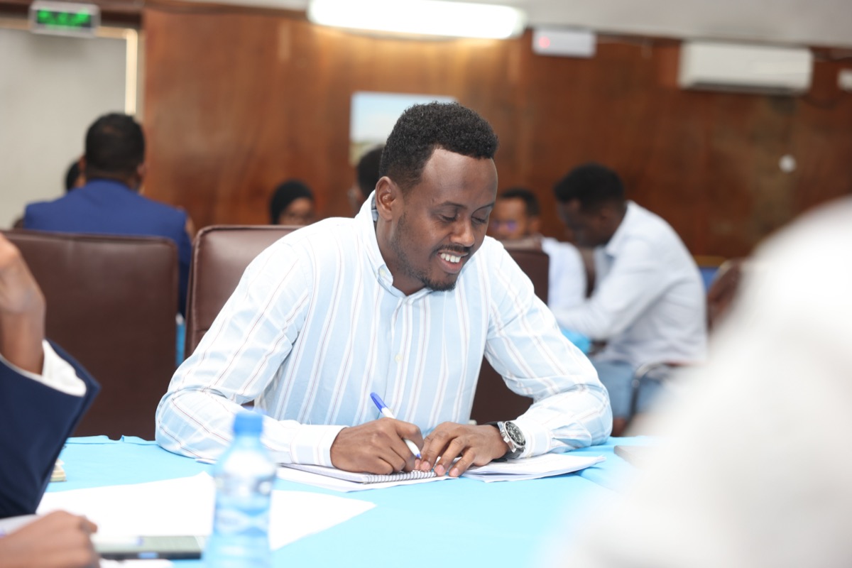 A delegate making notes during a session
